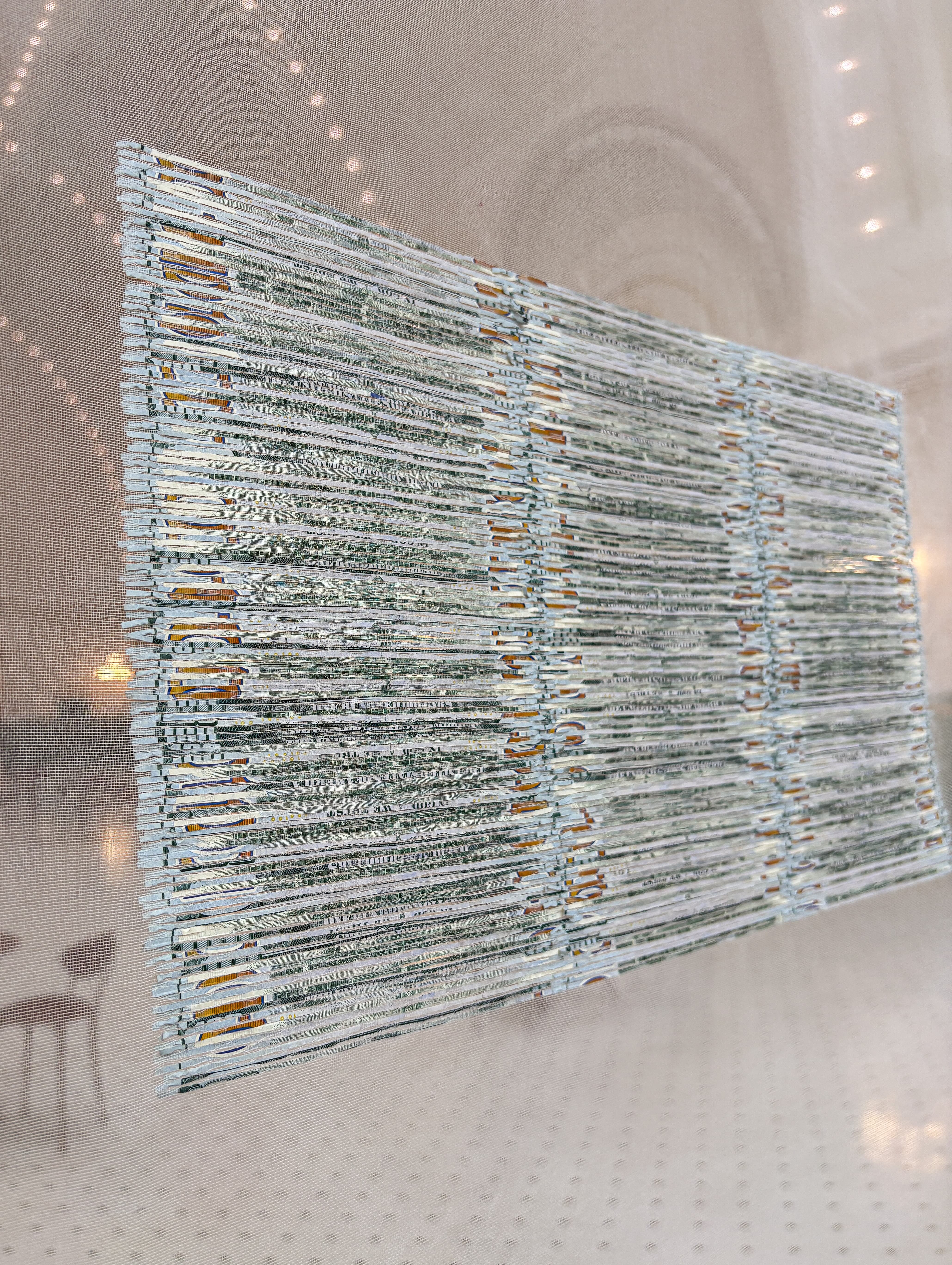 Oblique detail of reconstructed one-hundred-dollar bills.