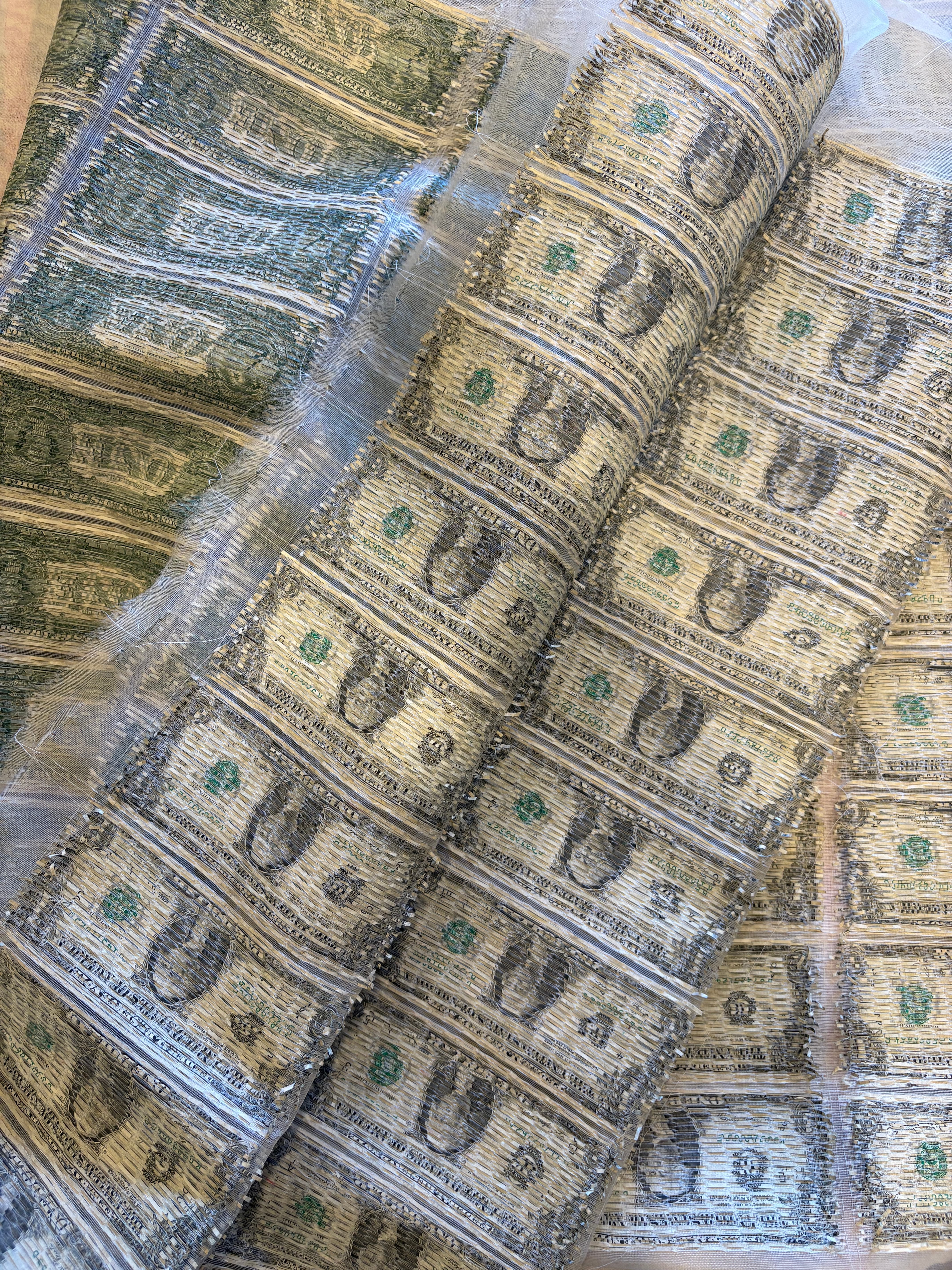 Reconstructed currency textile folded during fabrication.