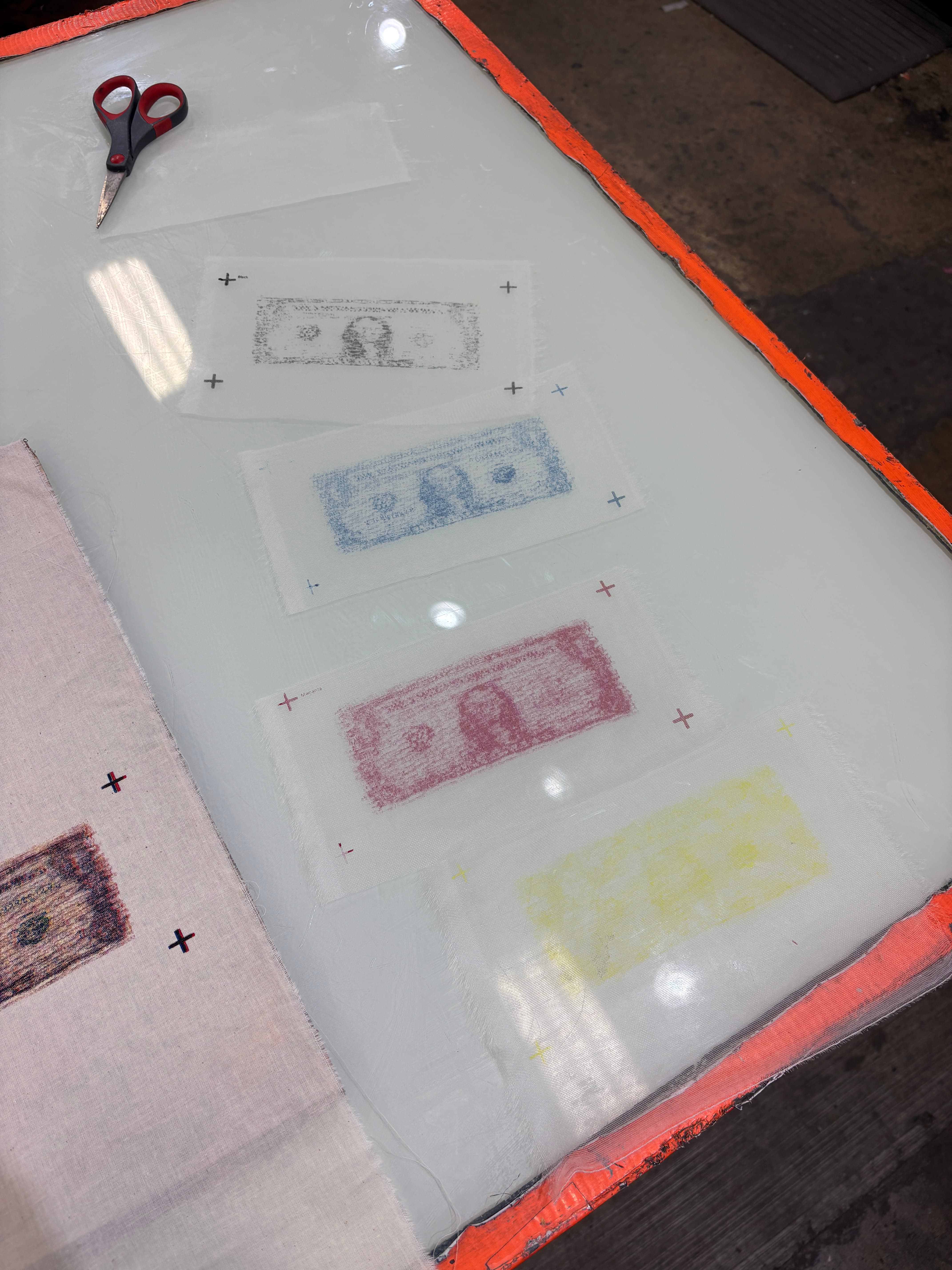CMYK screen-print separations arranged during testing.